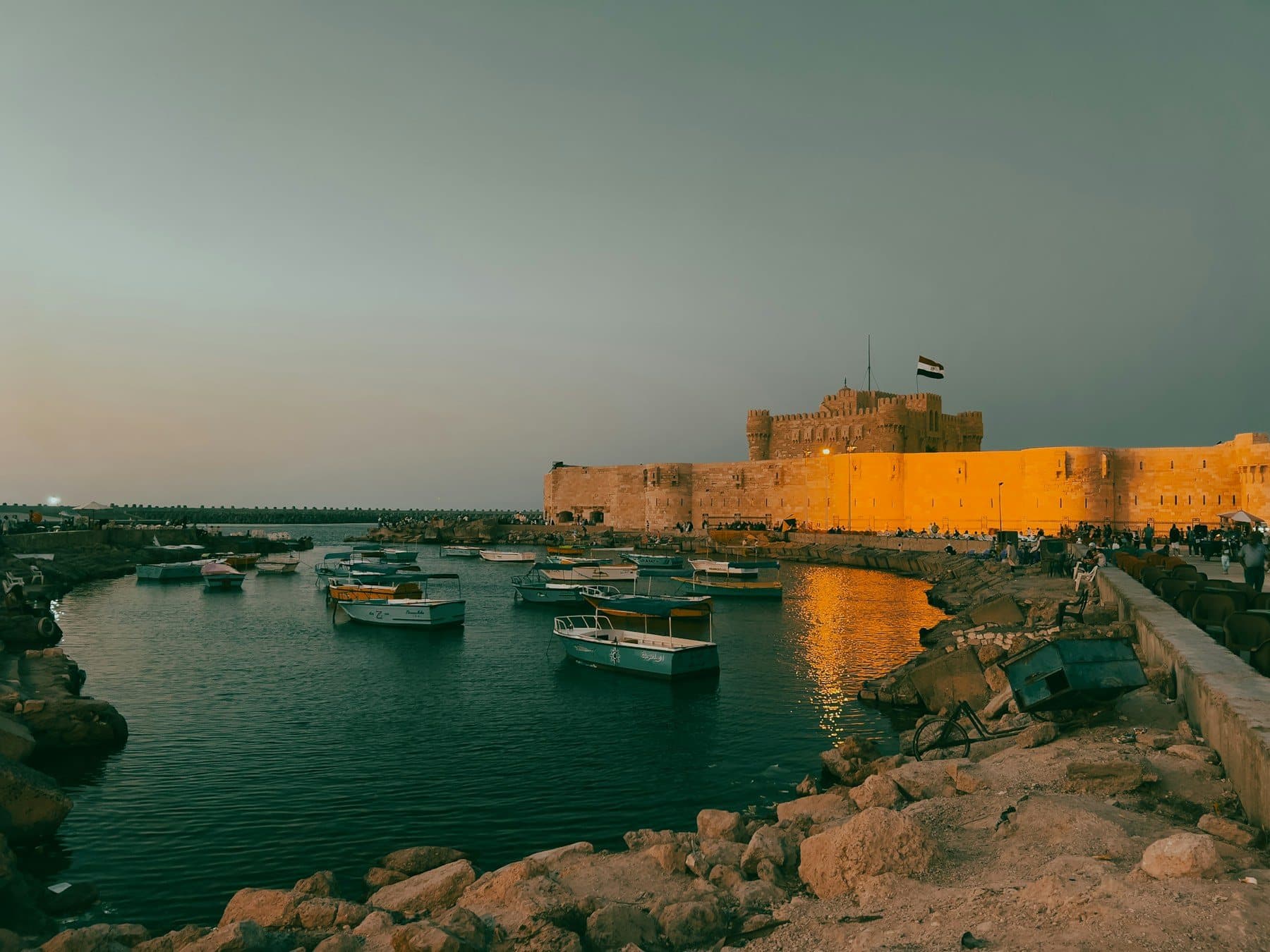 Citadel of Qaitbay glowing at sunset across Alexandria's eastern harbour
