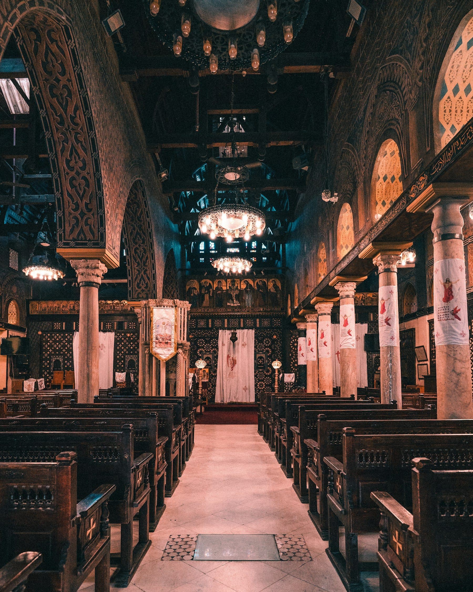 Candle-lit nave of a historic Coptic church in Cairo