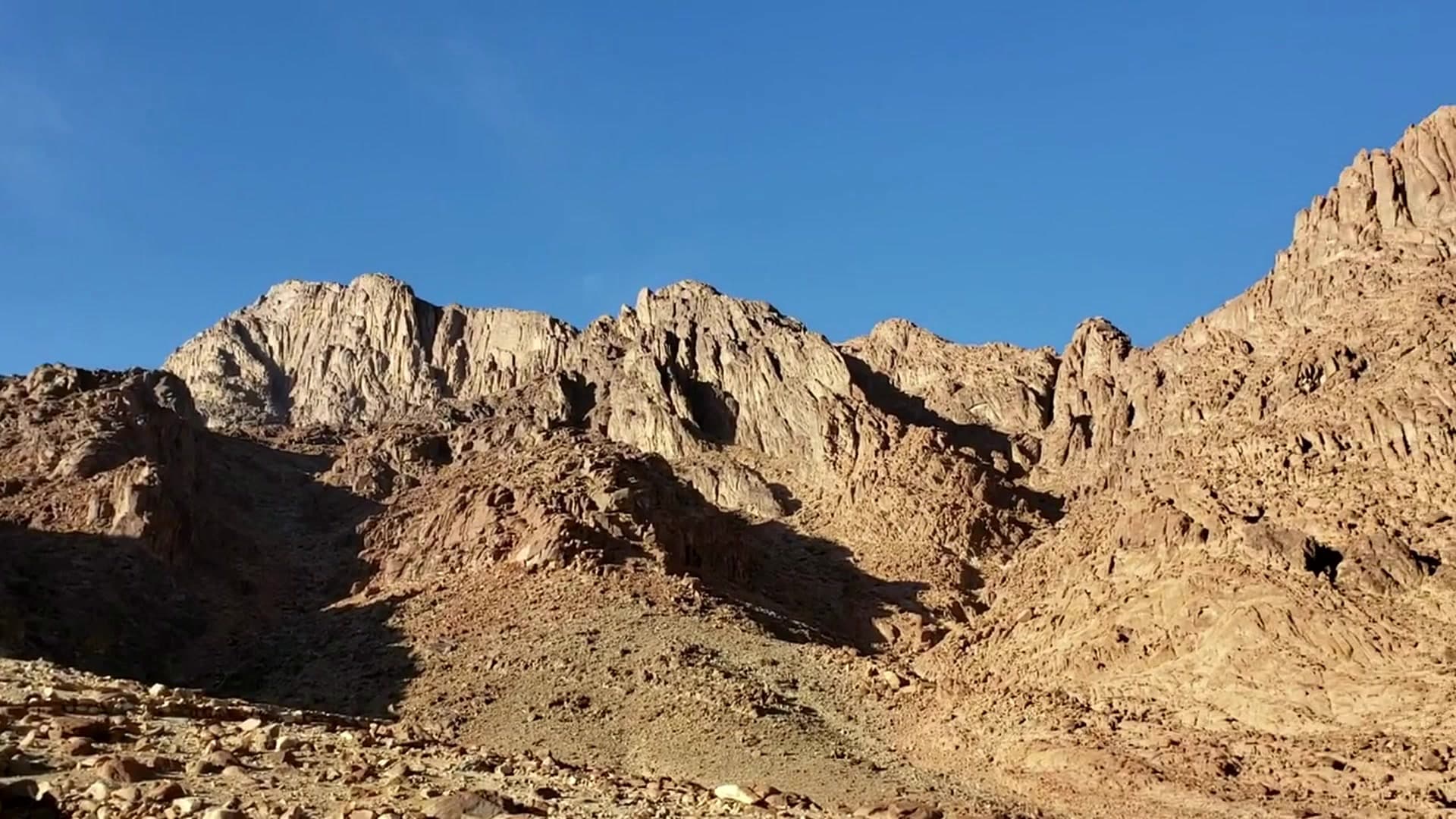 Travellers watching sunrise from the summit of Mount Sinai