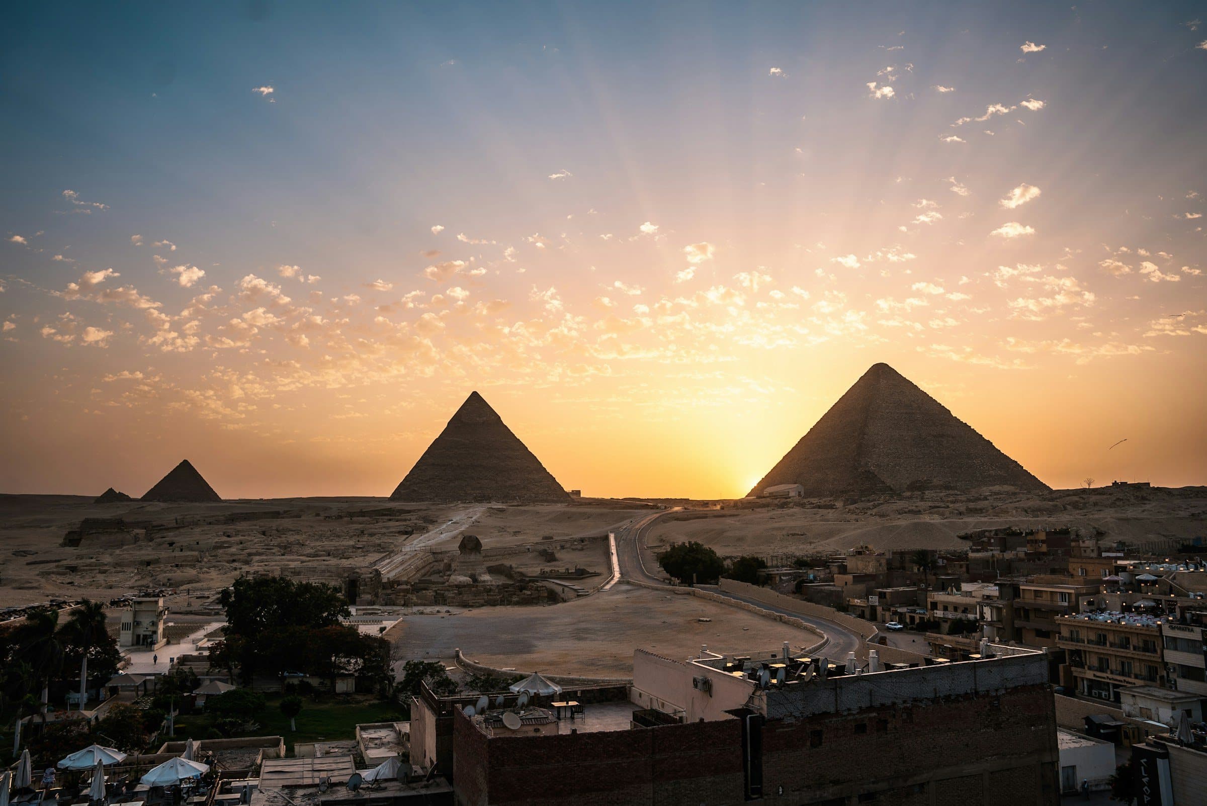 Sunrise over the Pyramids of Giza seen from the edge of Cairo