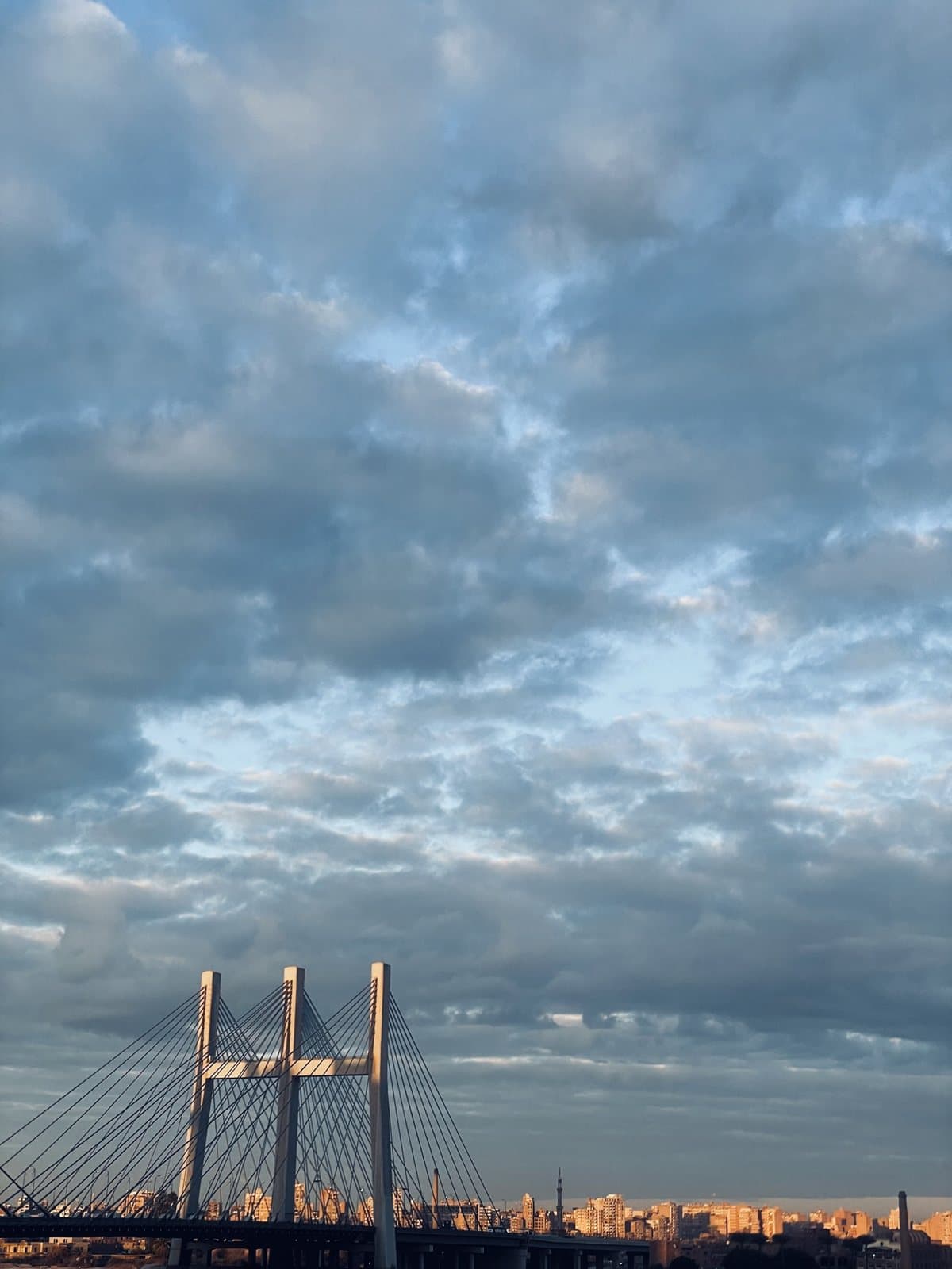 Sunset over a Cairo bridge and the city skyline