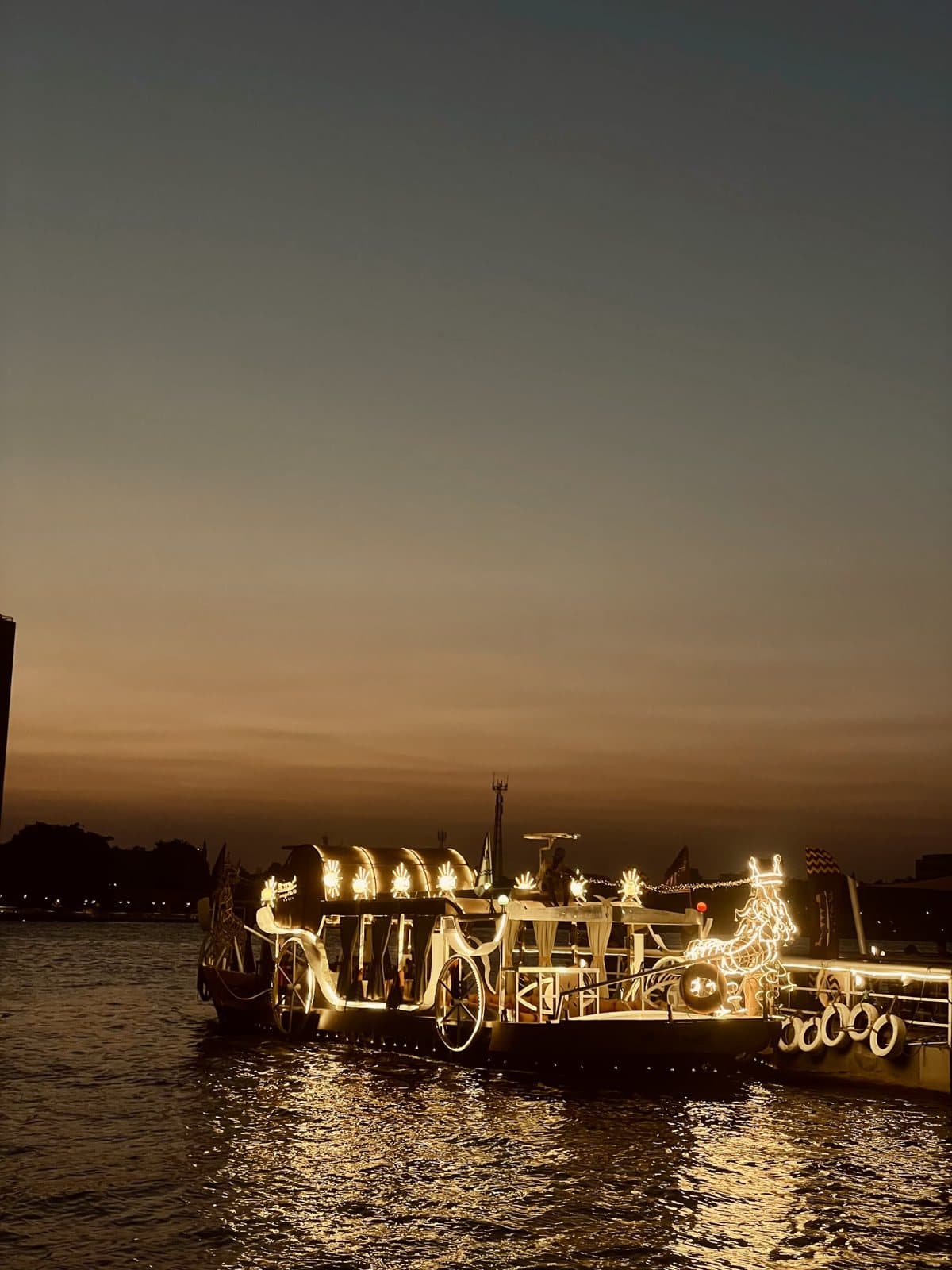 A lantern-lit boat on the Nile at dusk