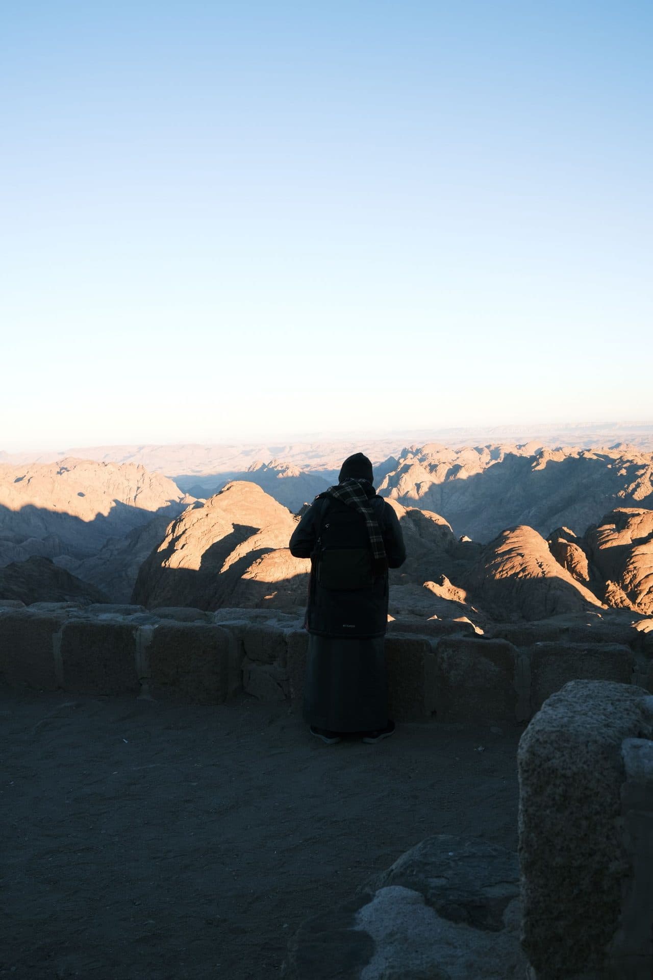 A pilgrim watching dawn break over the peaks of Mount Sinai