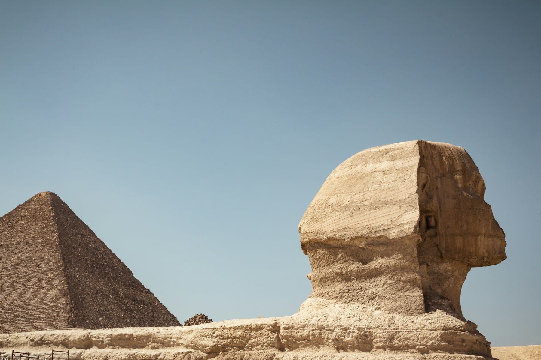 The Great Sphinx of Giza in profile against the Pyramid of Khafre